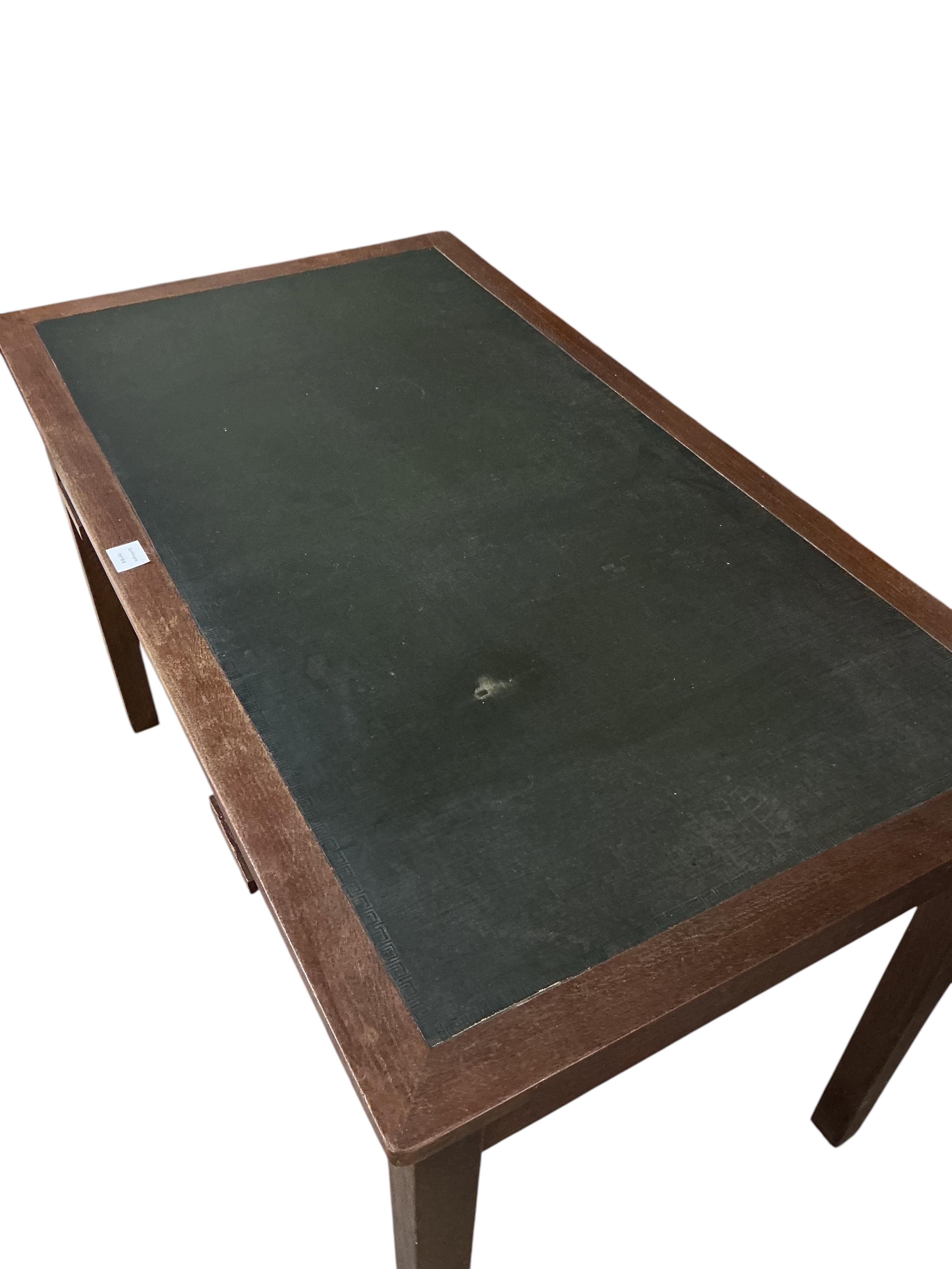 A 1920's oak two drawer writing table, A H Parker retailers, width 122cm, depth 69cm, height 77cm